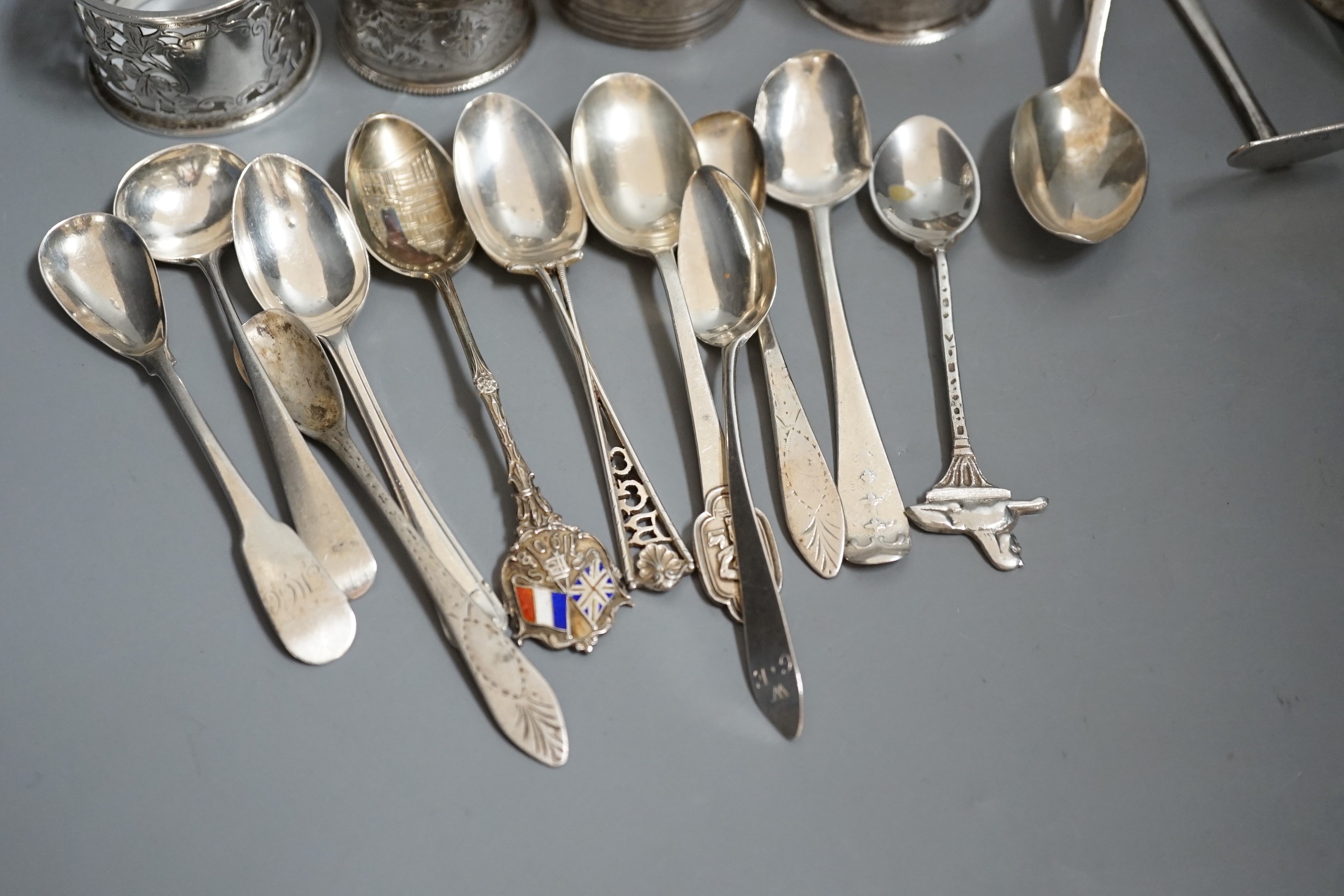 A miscellaneous collection of small silver items to include napkin rings, spoons, etc.